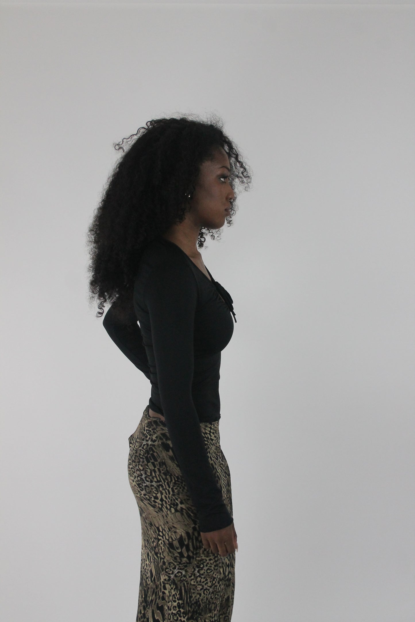 alternate-side view of black cutout-neckline long-sleeve top