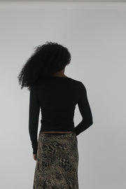 back view of black cutout-neckline long-sleeve top