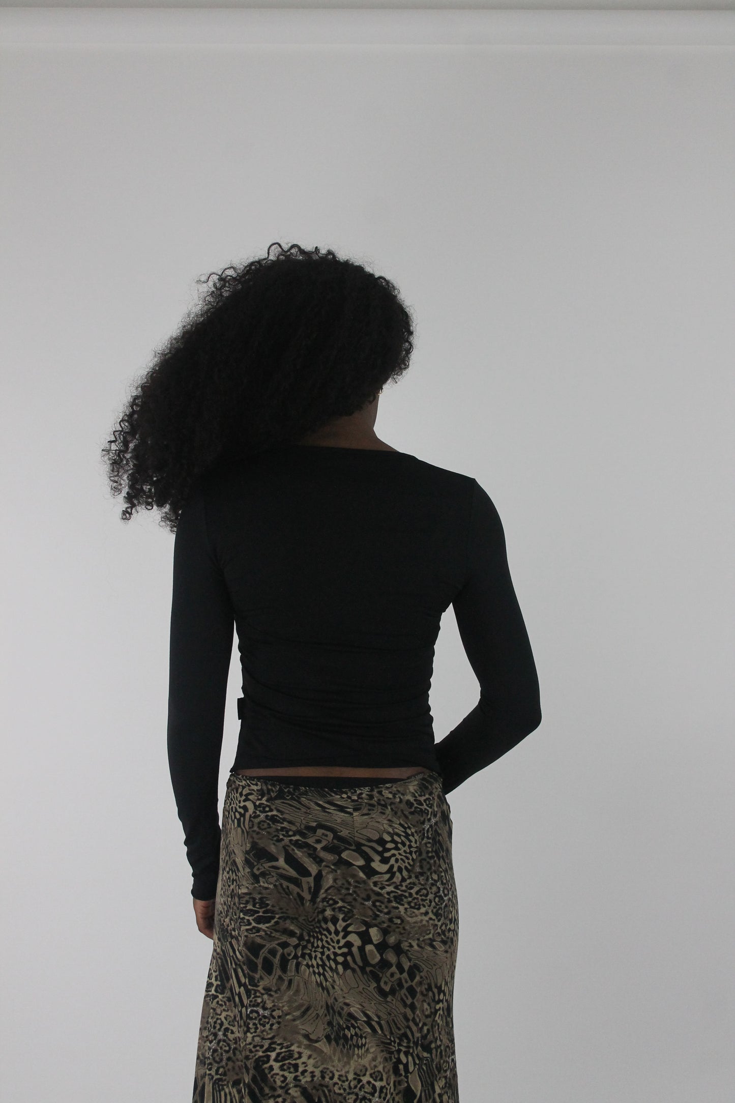 back view of black cutout-neckline long-sleeve top