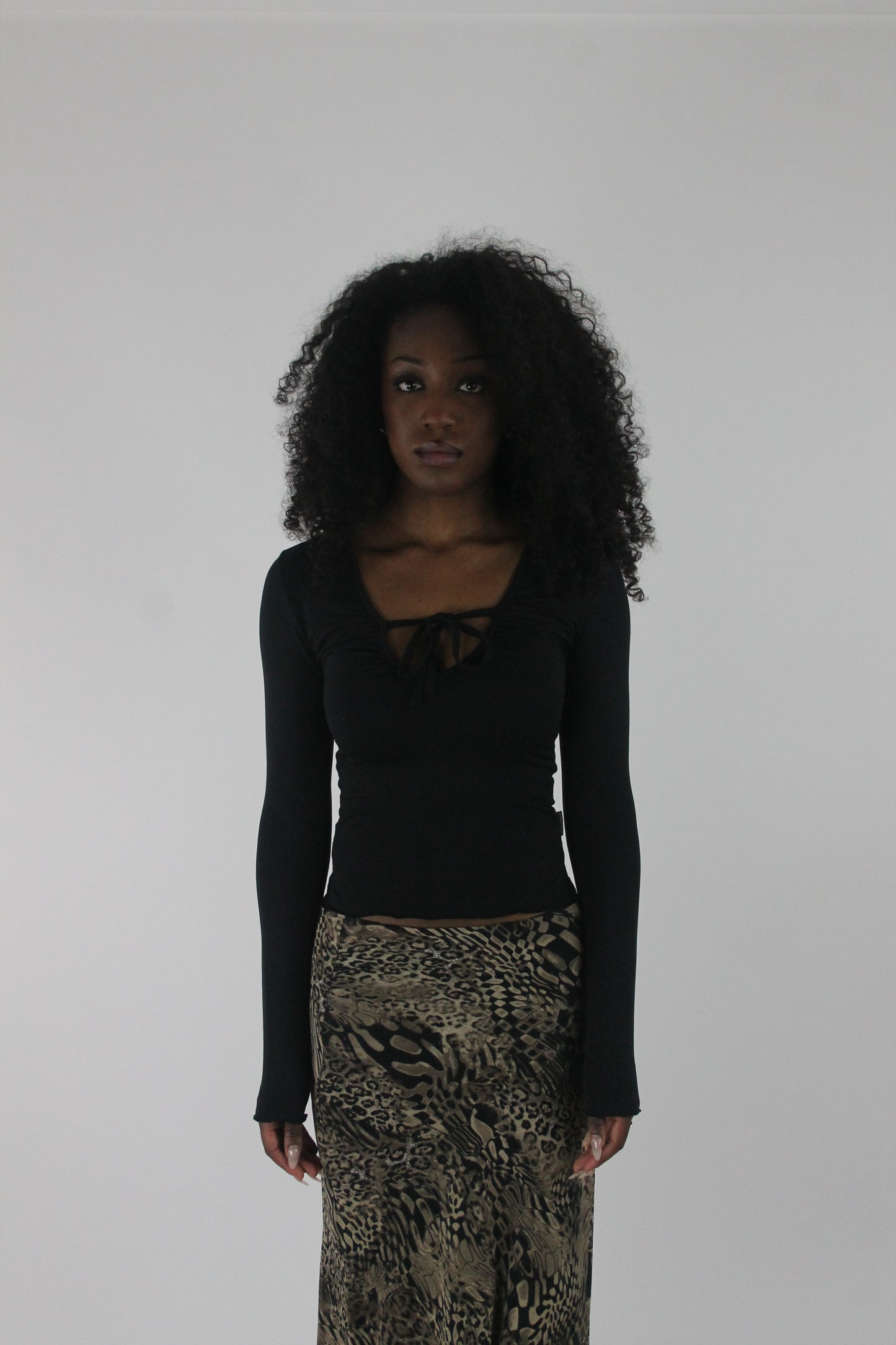 front view of black cutout-neckline long-sleeve top