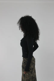 side view of black cutout-neckline long-sleeve top