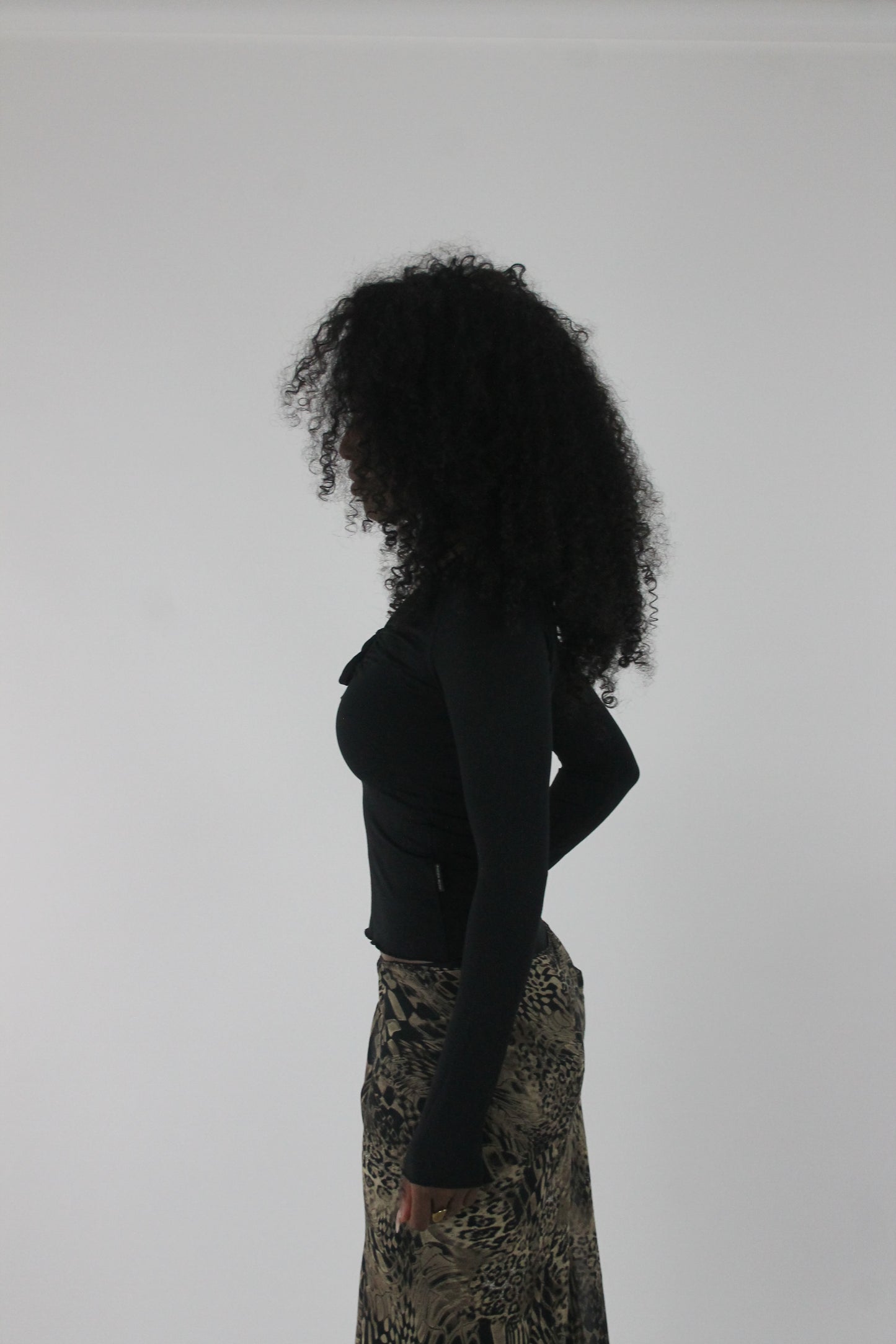 side view of black cutout-neckline long-sleeve top