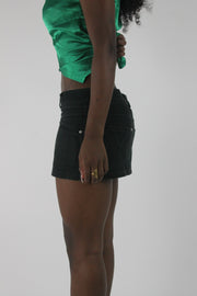 side view of black denim pocket-detail mini skirt