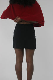 back view of black fitted tailored mini skirt