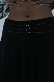 detail view of black flared eyelet-waist mini skirt
