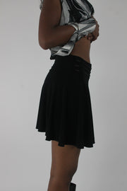 side view of black flared eyelet-waist mini skirt