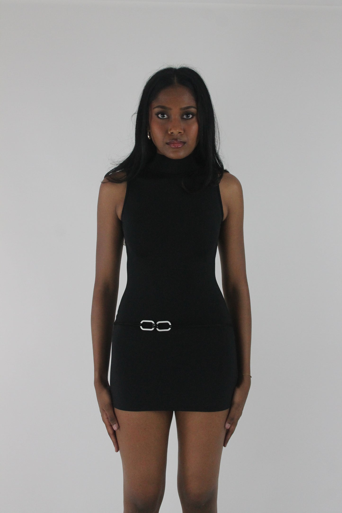 front view of black high-neck sleeveless buckle-detail mini dress