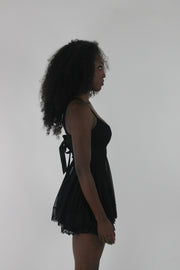 alternate-side view of black lace-trim babydoll mini dress