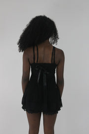 back view of black lace-trim babydoll mini dress