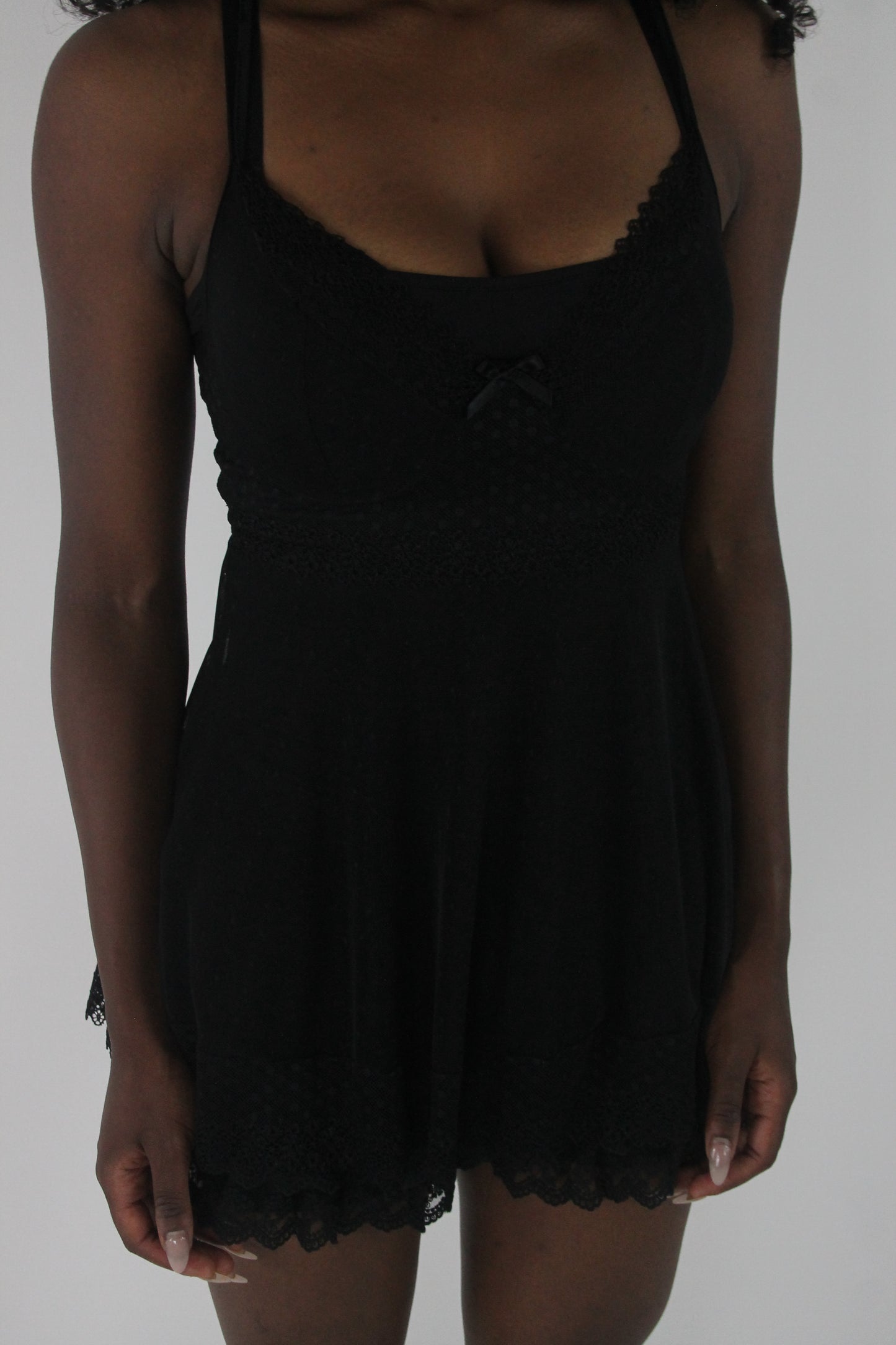 detail view of black lace-trim babydoll mini dress