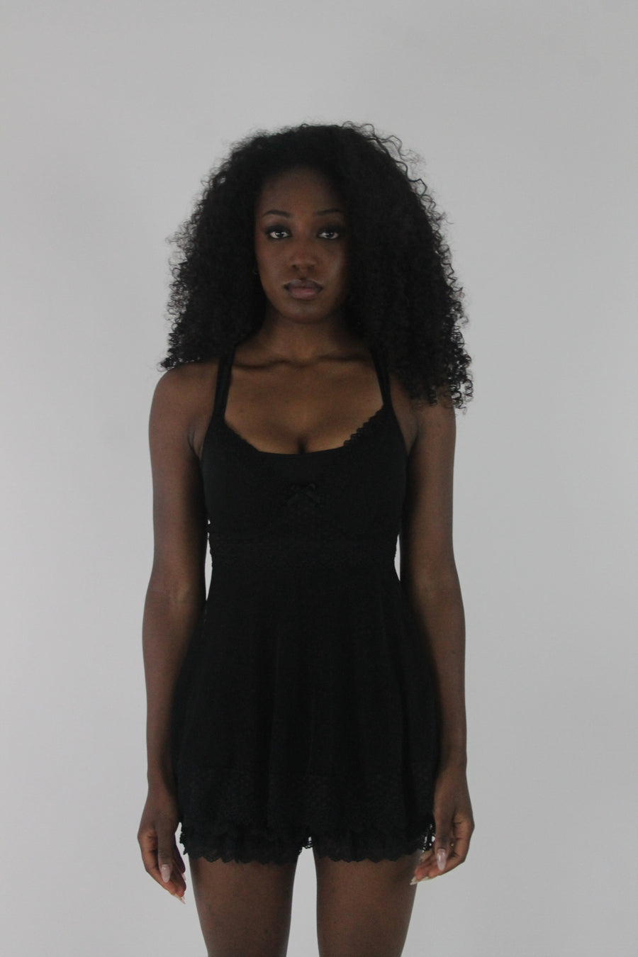front view of black lace-trim babydoll mini dress