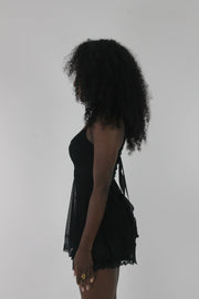 side view of black lace-trim babydoll mini dress