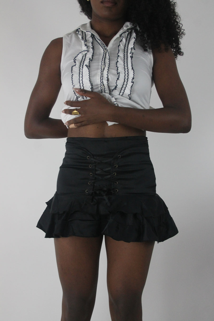 front view of black lace-up ruffle mini skirt