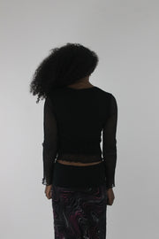back view of black mesh ruffle-hem long-sleeve top