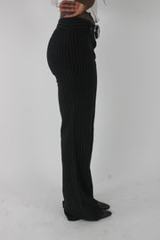 alternate-side view of black pinstripe buckle-belt flared trousers