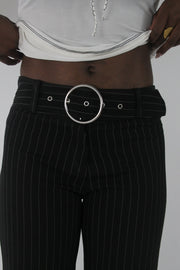 detail view of black pinstripe buckle-belt flared trousers