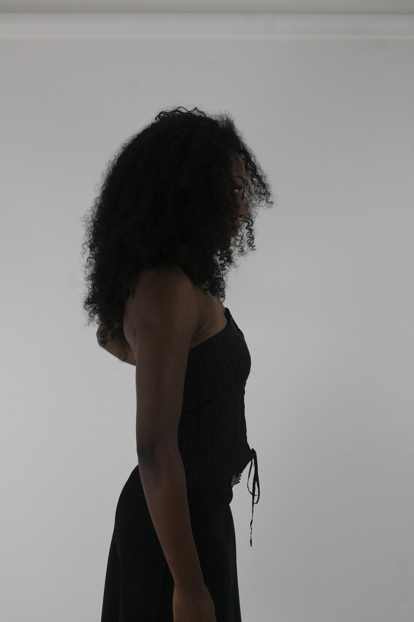 alternate-side view of black pinstripe lace-up corset top