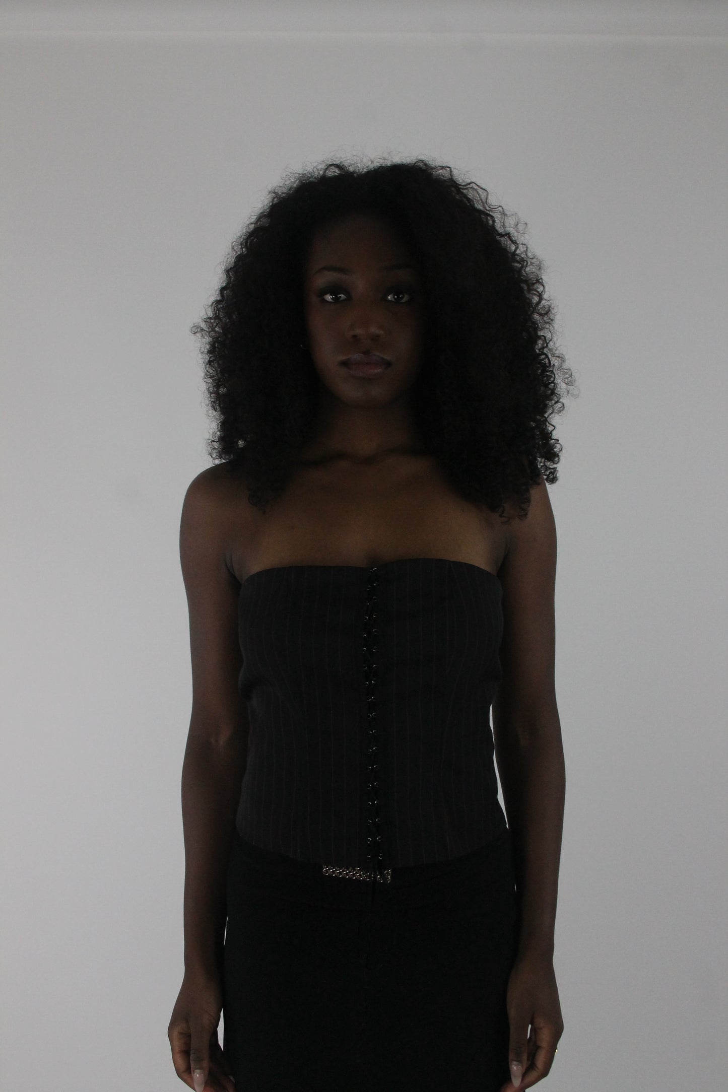 front view of black pinstripe lace-up corset top
