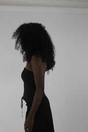 side view of black pinstripe lace-up corset top
