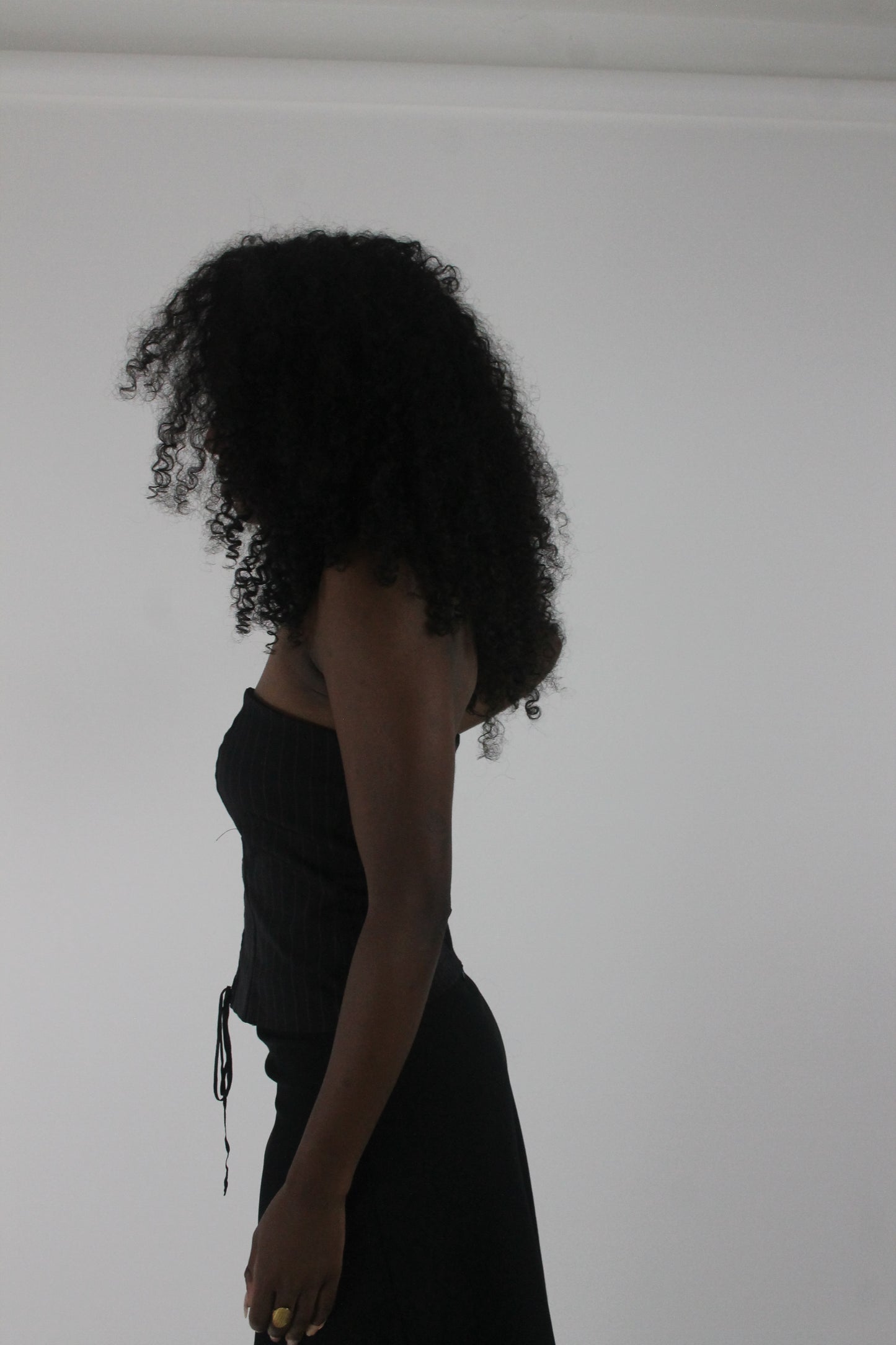 side view of black pinstripe lace-up corset top