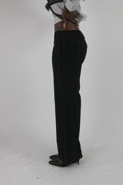 side view of black pinstripe wide-leg trousers