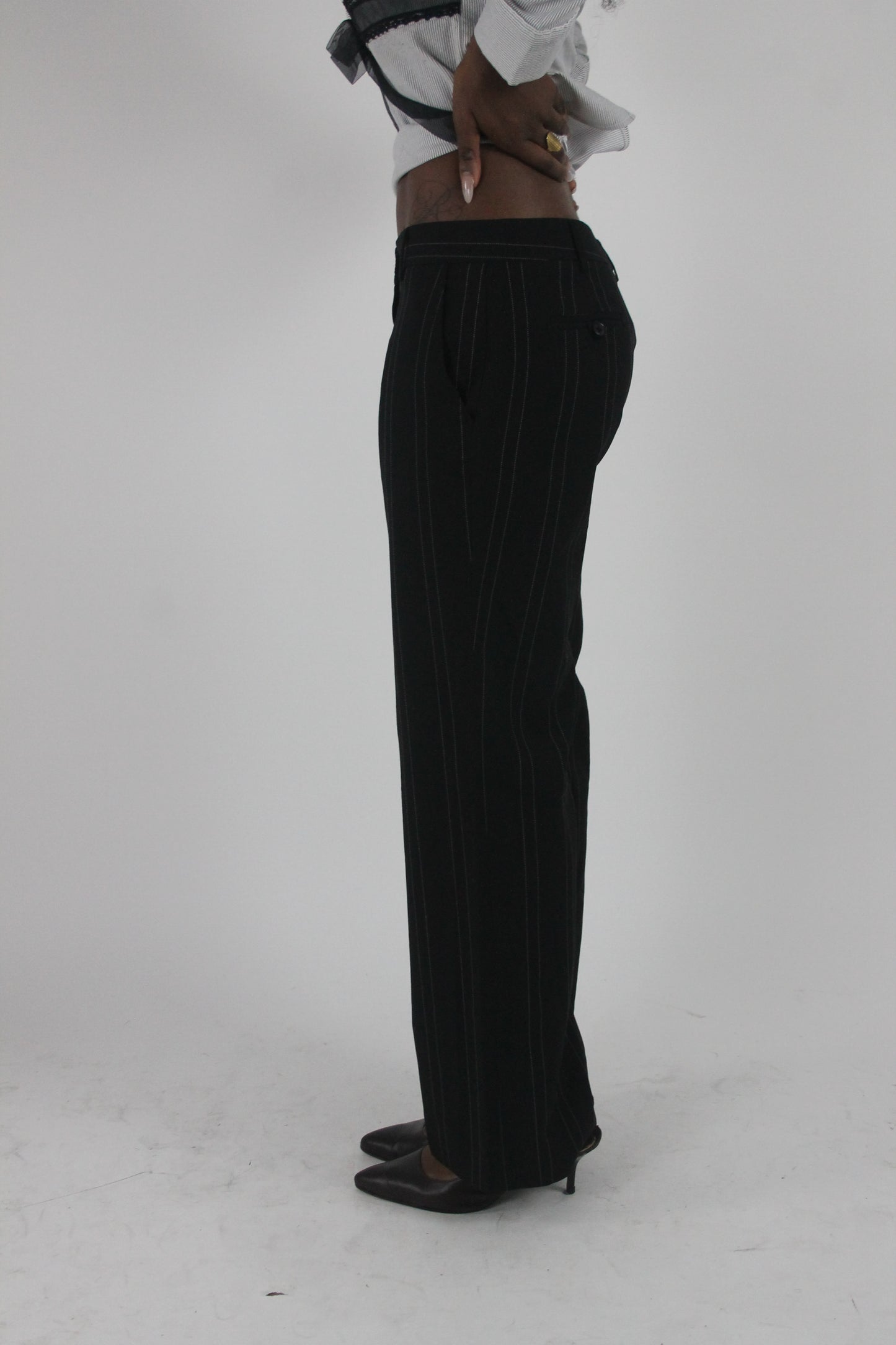 side view of black pinstripe wide-leg trousers
