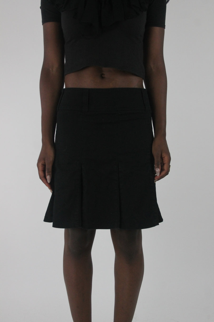 front view of black pleated mini skirt