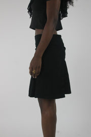 side view of black pleated mini skirt