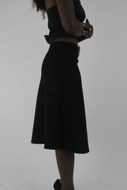 alternate-side view of black rhinestone-buckle midi skirt