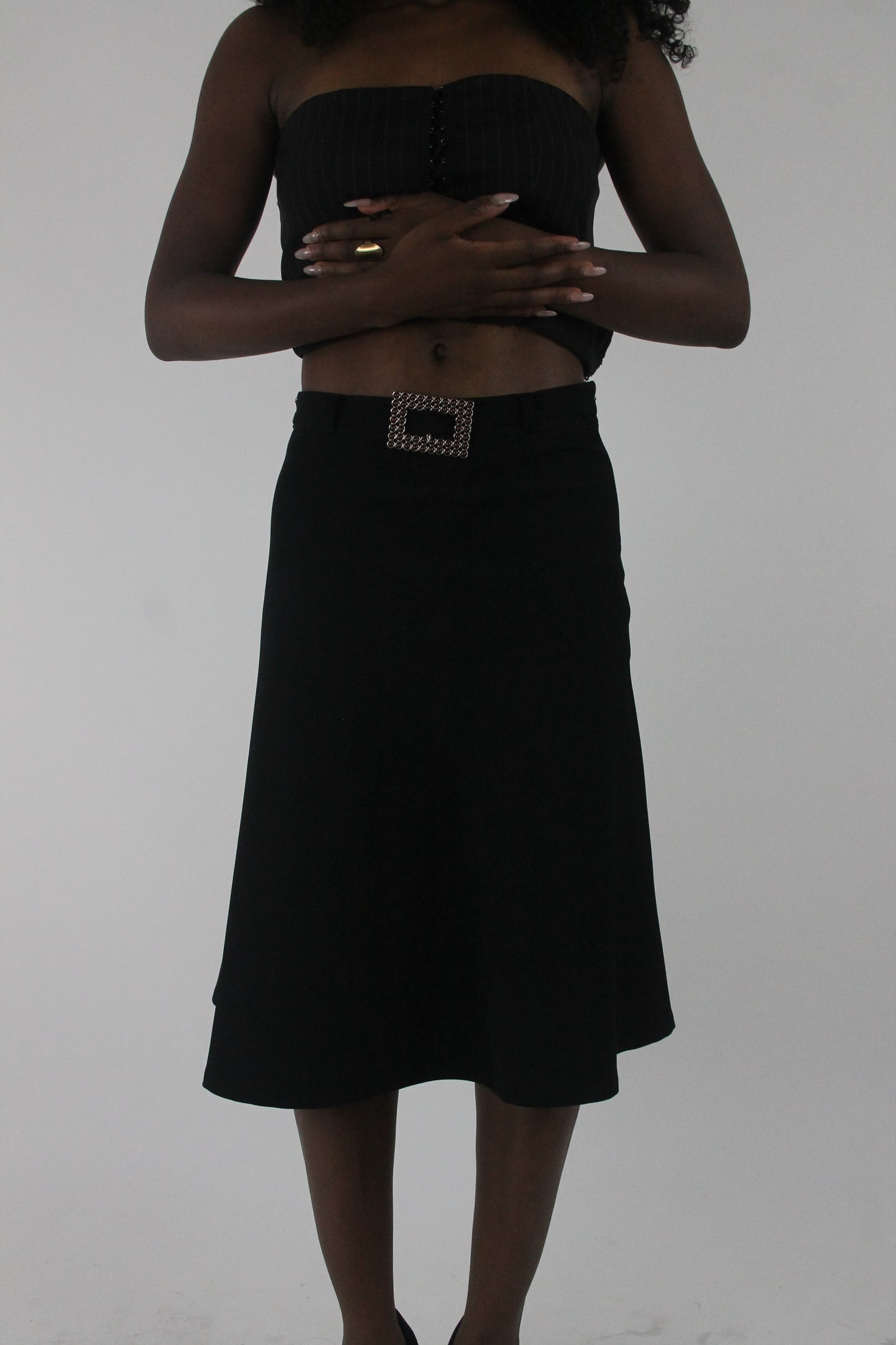 front view of black rhinestone-buckle midi skirt
