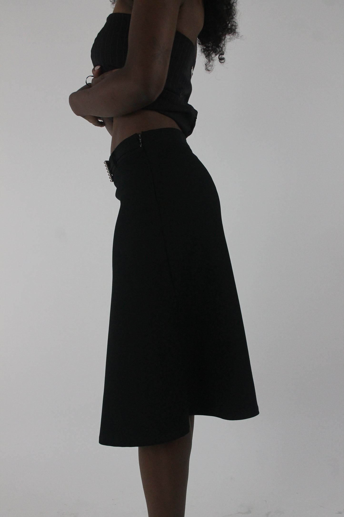 side view of black rhinestone-buckle midi skirt
