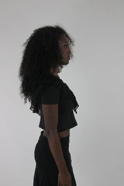 alternate-side view of black ruffle cropped short-sleeve top