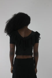 back view of black ruffle cropped short-sleeve top
