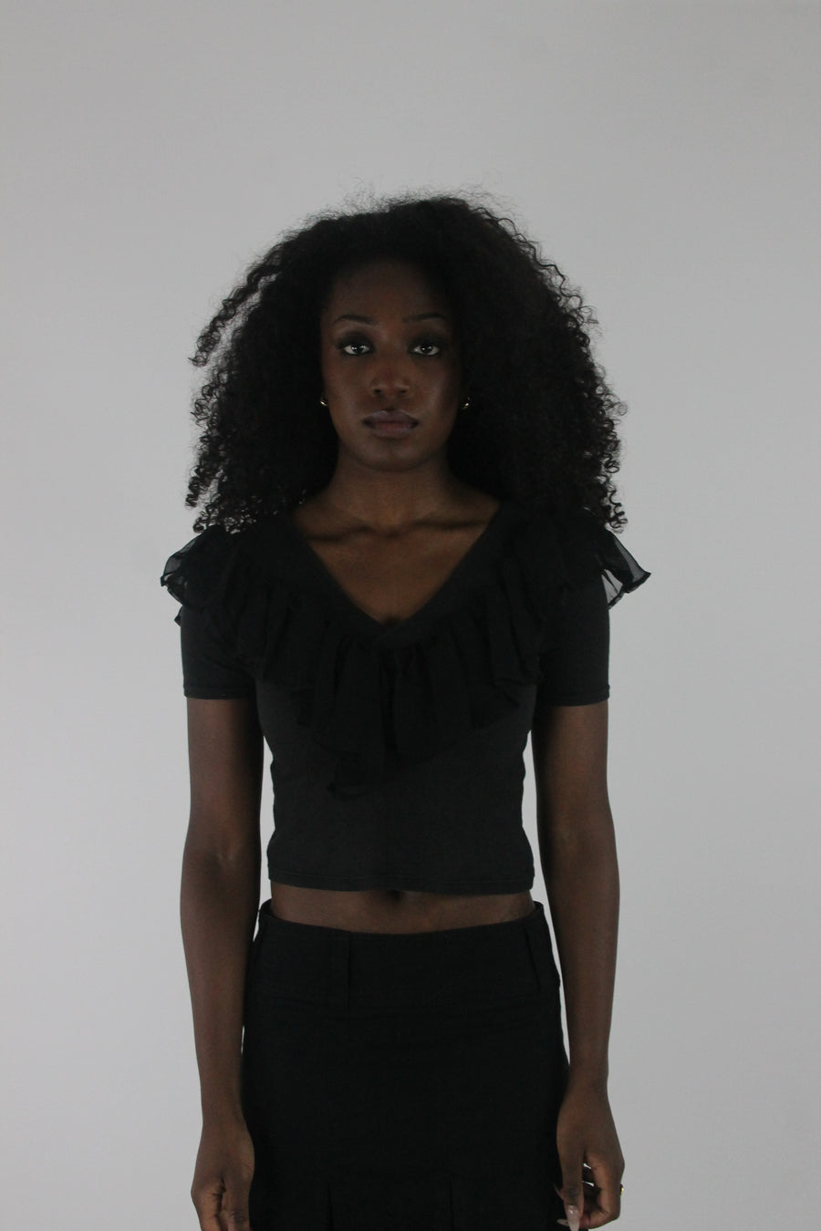 front view of black ruffle cropped short-sleeve top