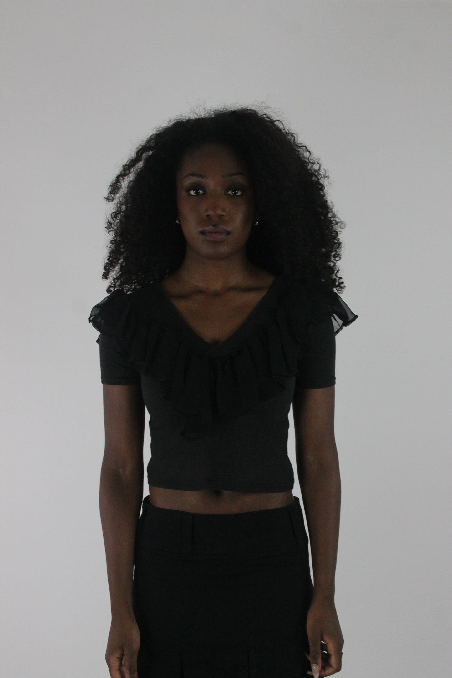 front view of black ruffle cropped short-sleeve top