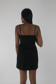 back view of black satin-effect camisole mini dress