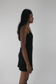 side view of black satin-effect camisole mini dress