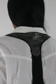 alternate-side view of black studded racerback cropped waistcoat