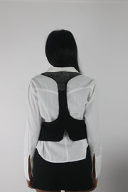back view of black studded racerback cropped waistcoat