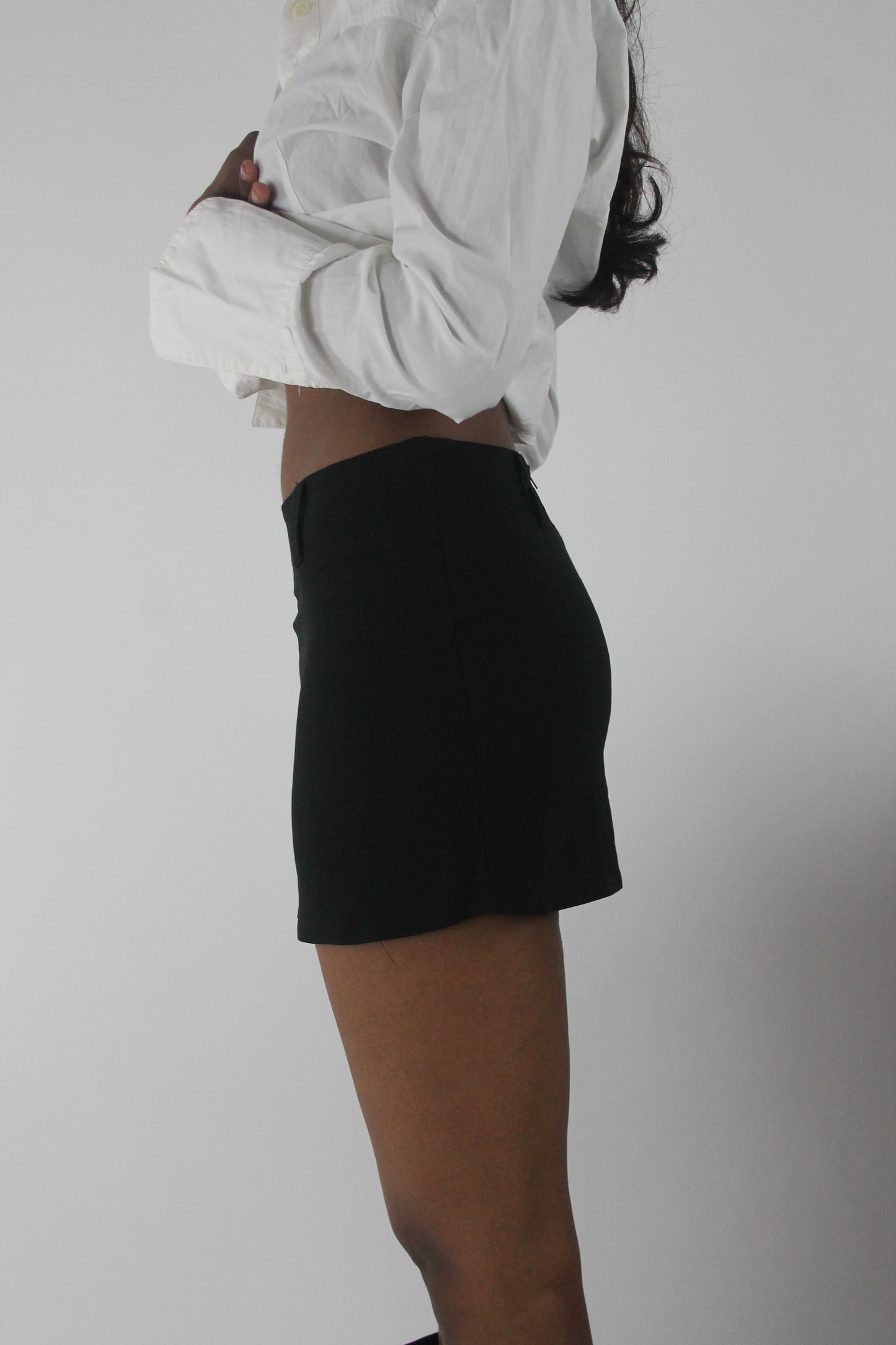 alternate-side view of black tailored mini skirt