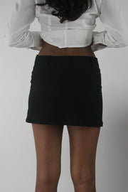 back view of black tailored mini skirt