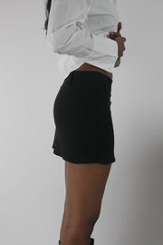 side view of black tailored mini skirt