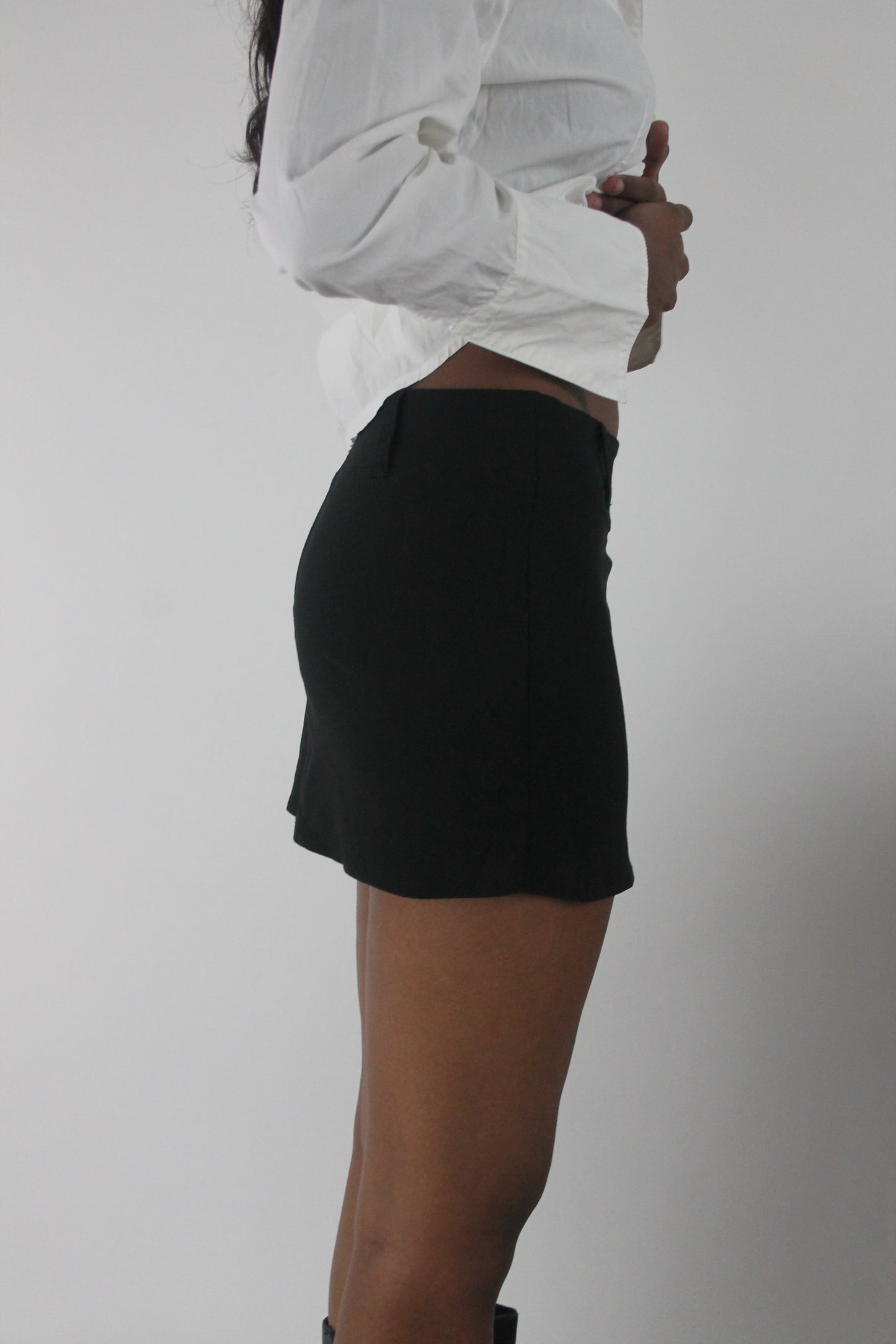 side view of black tailored mini skirt