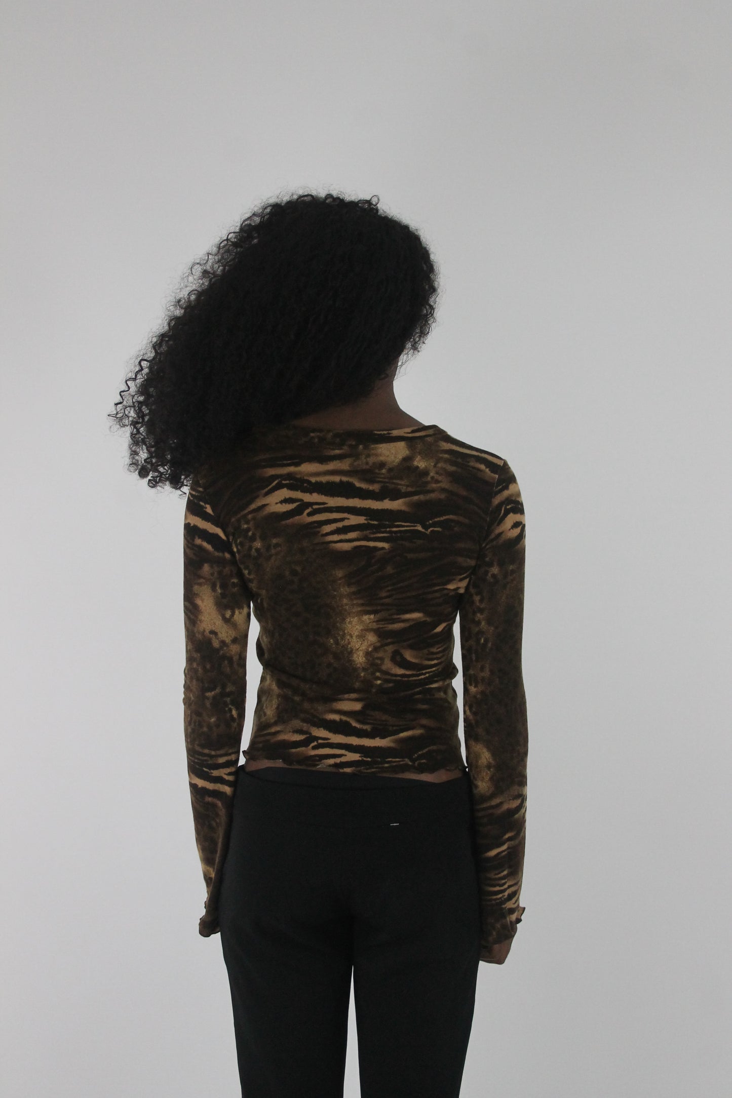 back view of brown zebra-print long-sleeve top