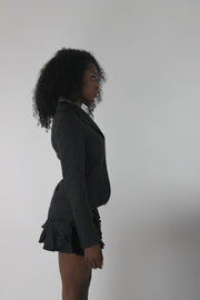 alternate-side view of charcoal grey ruffle-hem fitted blazer