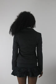 back view of charcoal grey ruffle-hem fitted blazer