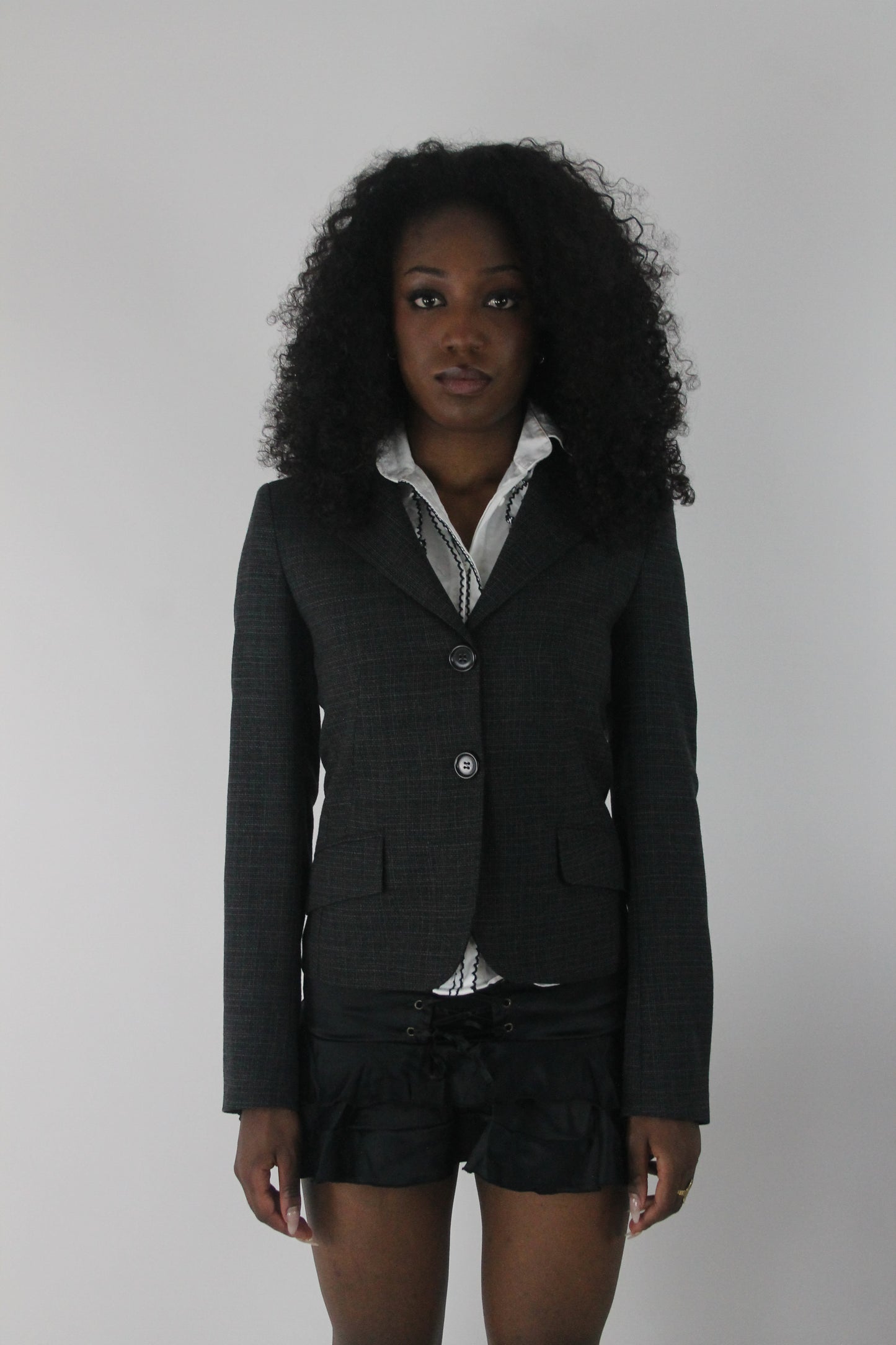 front view of charcoal grey ruffle-hem fitted blazer