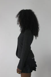 side view of charcoal grey ruffle-hem fitted blazer