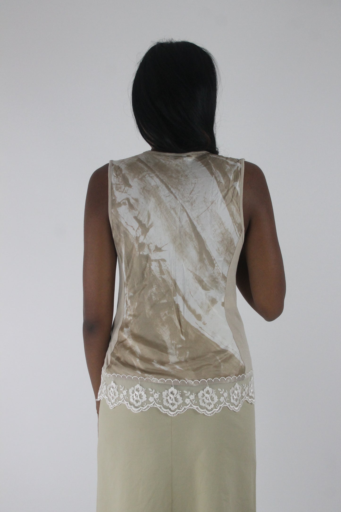 back view of small cream satin-effect sleeveless top with white lace trim