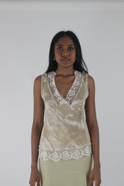 front view of small cream satin-effect sleeveless top with white lace trim